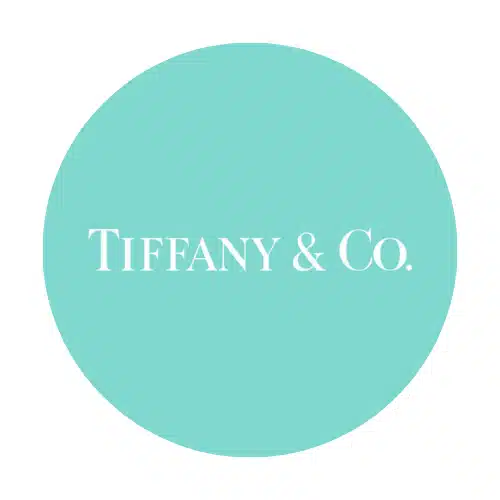 The Tiffany & Co. logo, an exemplar of branding elegance, showcases crisp white text set against a turquoise circular background.